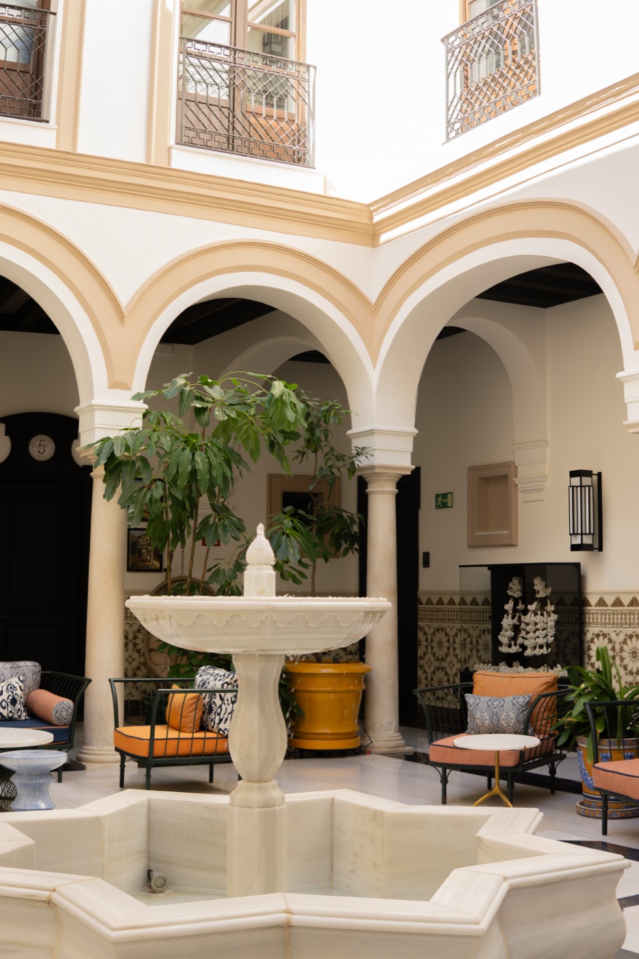 Courtyard with arches, a fountain and plants at Hotel Palacio Don Ramón, Sevilla