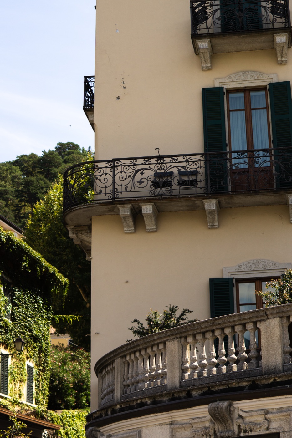 Villa facade with green shutters and a wrought iron balcony